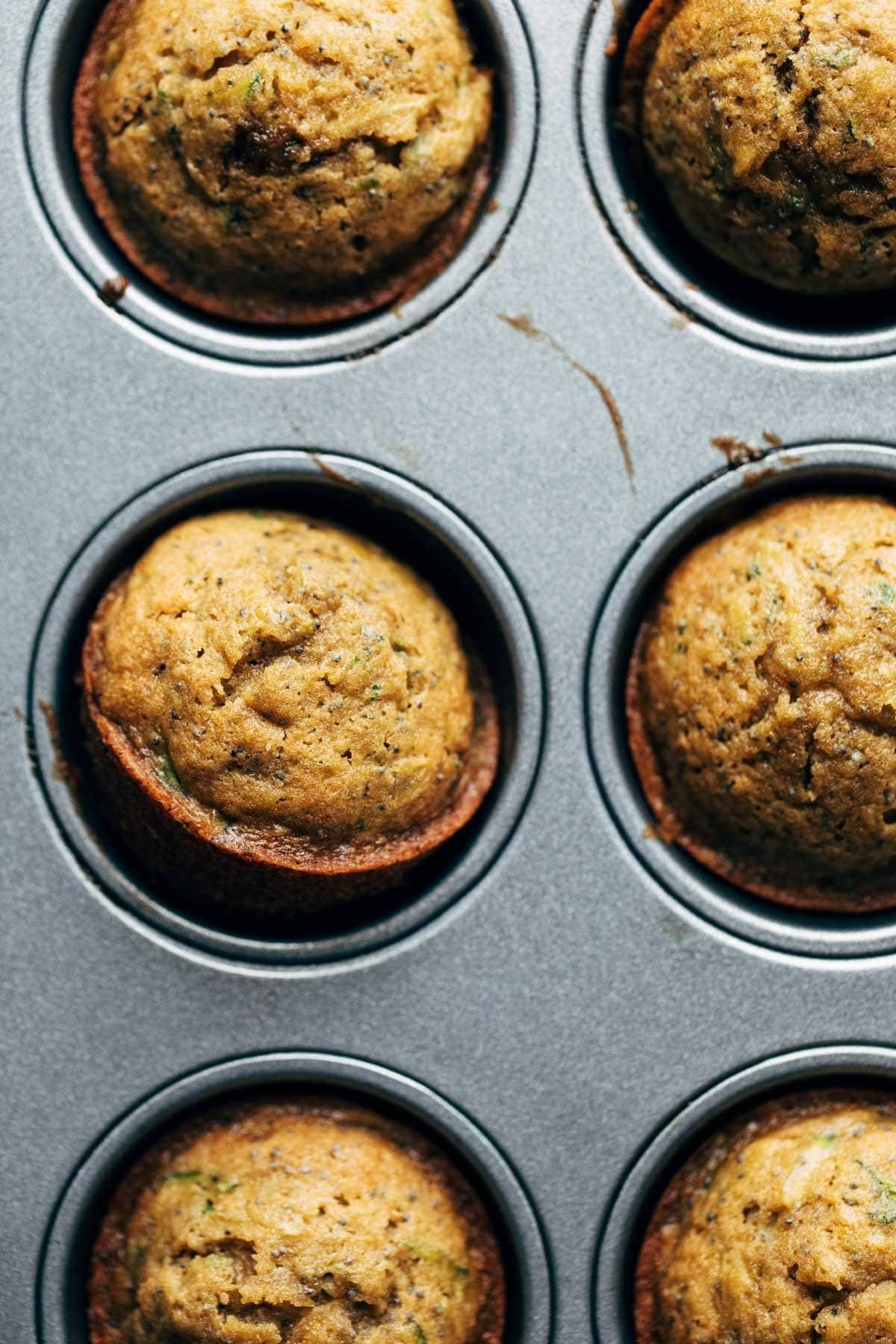 Lemon poppyseed zucchini muffins in muffin pan.