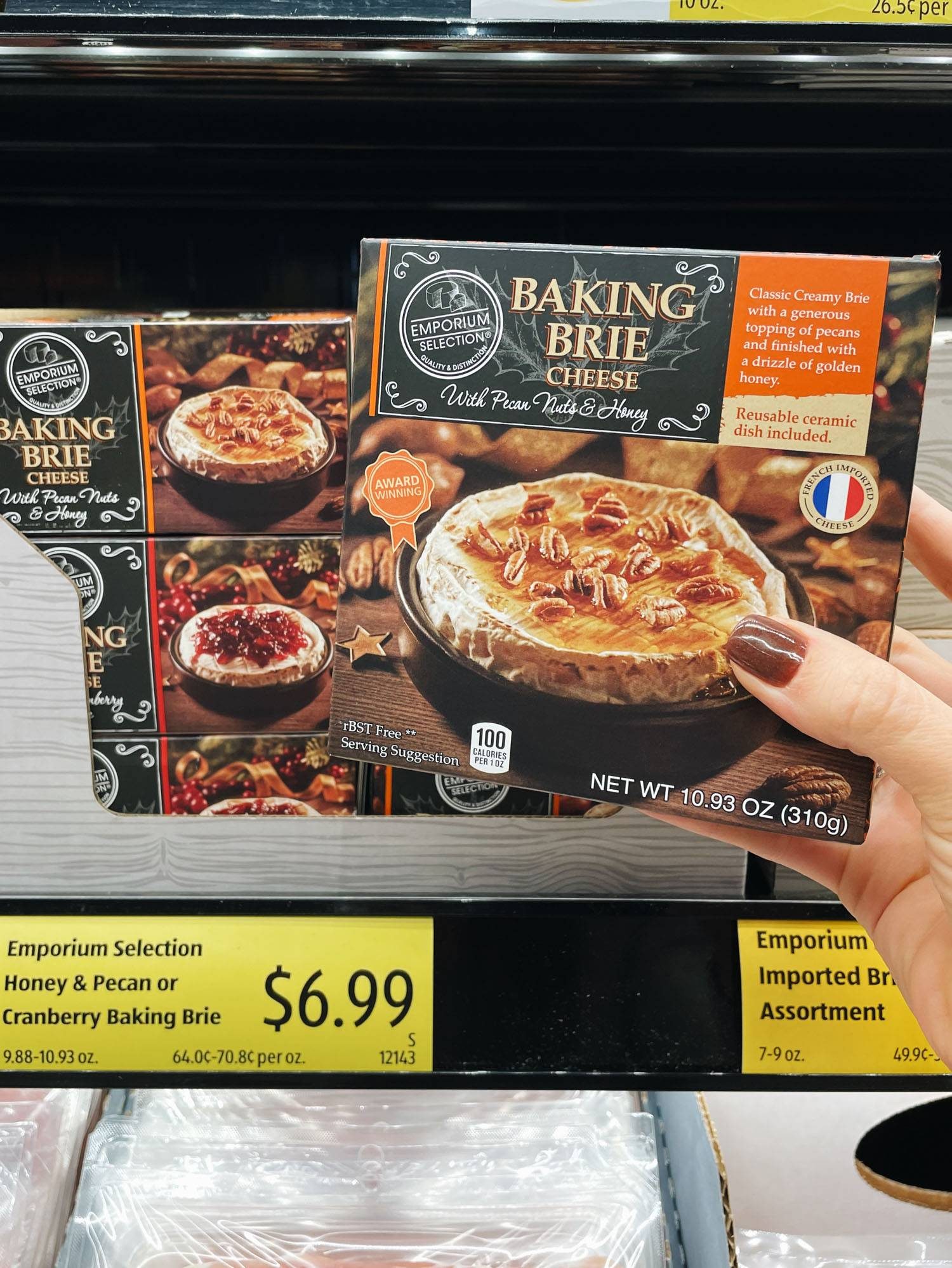 White hand holding baking brie