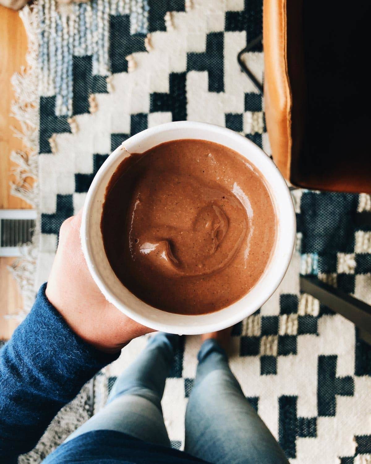 A person holding a white mug.