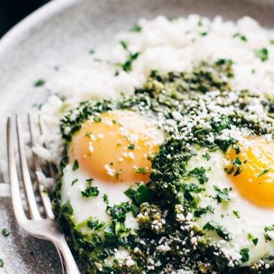 Green Shakshuka on a plate with rice.