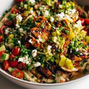 Grilled chicken with pepperoncini garlic butter on a platter