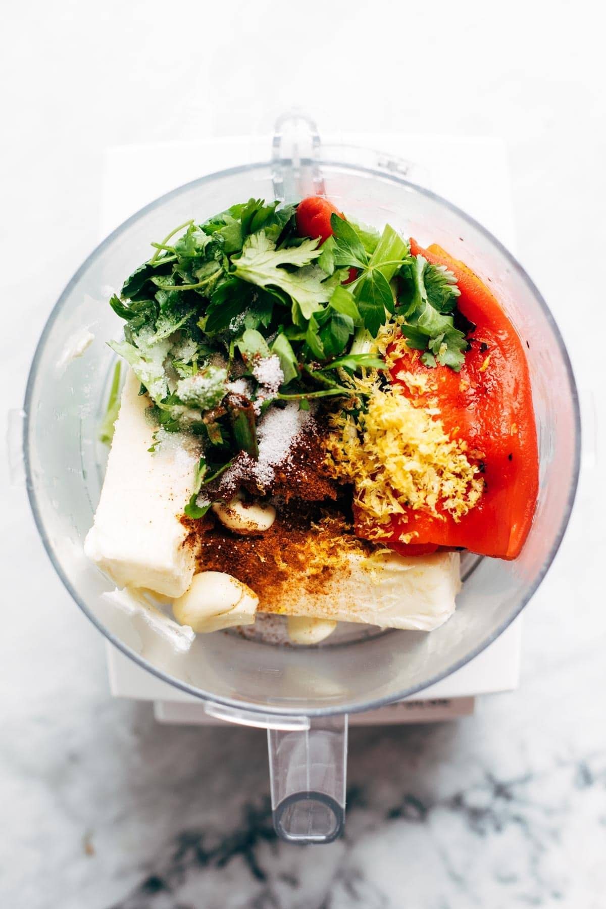 Ingredients for red pepper butter in a food processor.