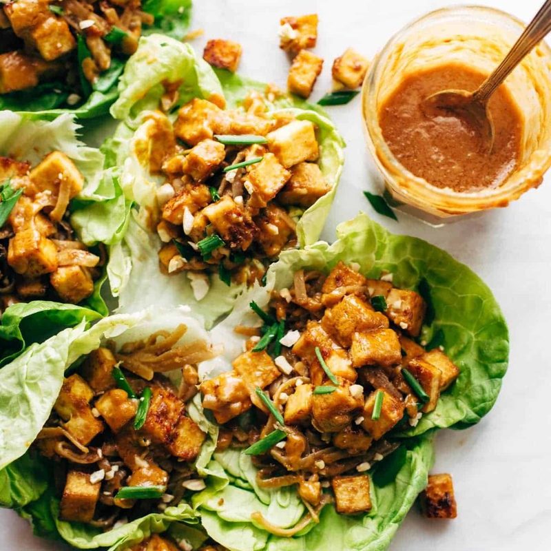 Firecracker Vegan Lettuce wraps in a row with hand.