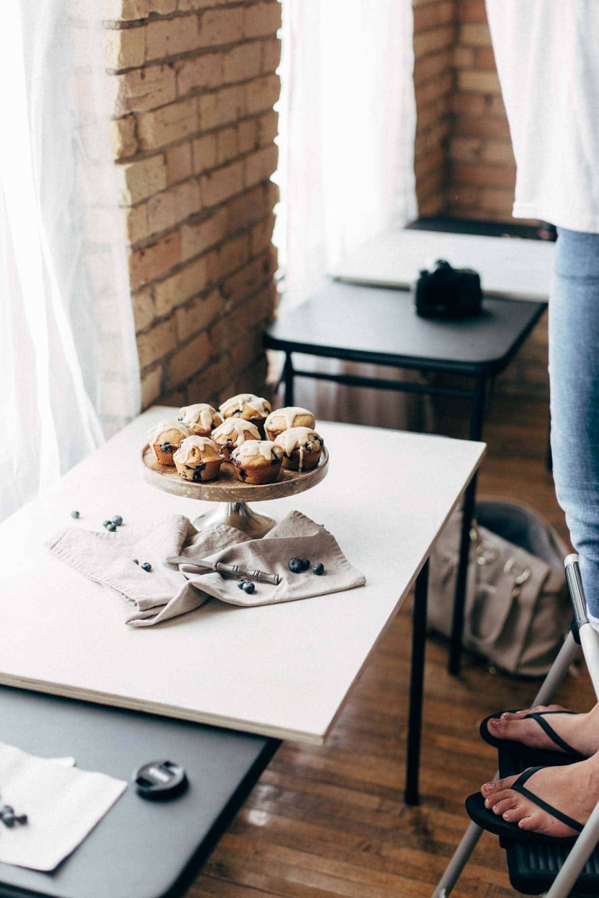 Cake stand with muffins on a table.