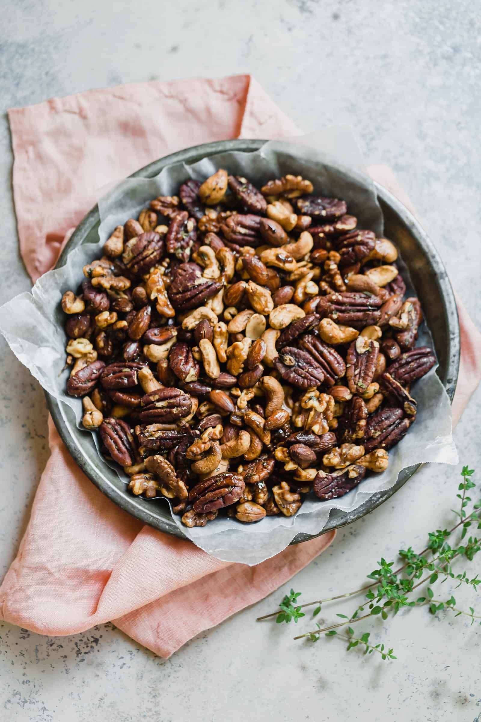 Spiced nuts in a bowl with wax paper