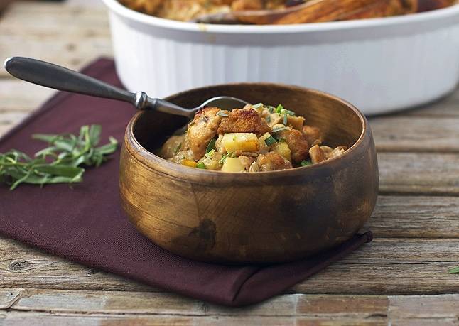 A bowl with food on a wooden surface.