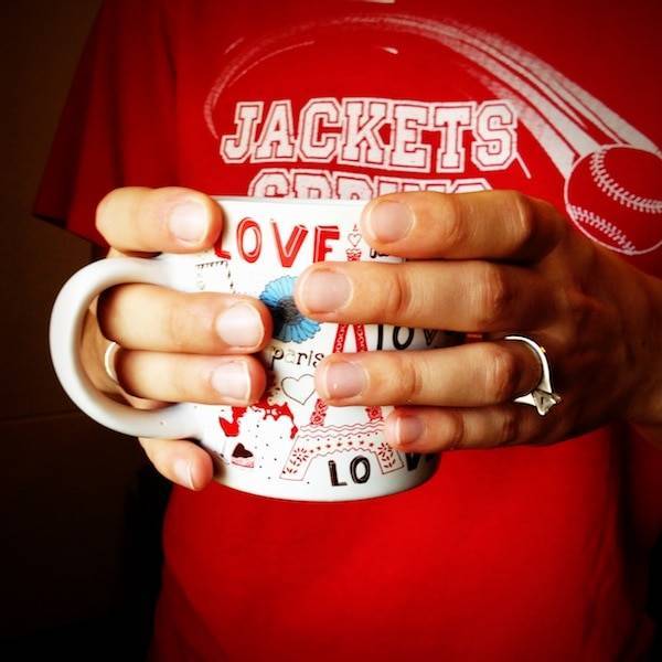 Hands holding a mug.