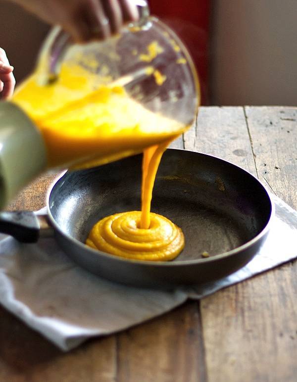Curry sauce pouring into a skillet.