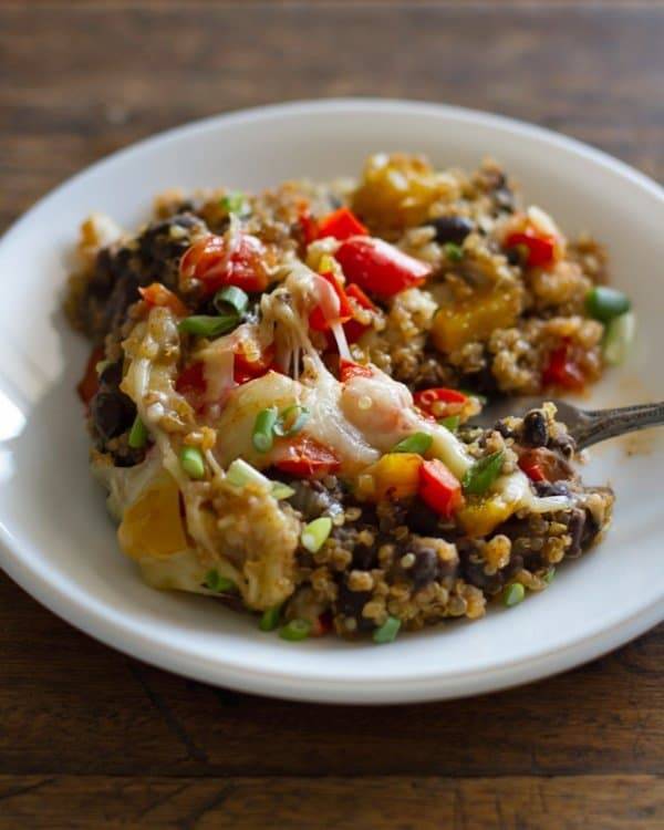 Quinoa and black bean casserole in a white bowl.