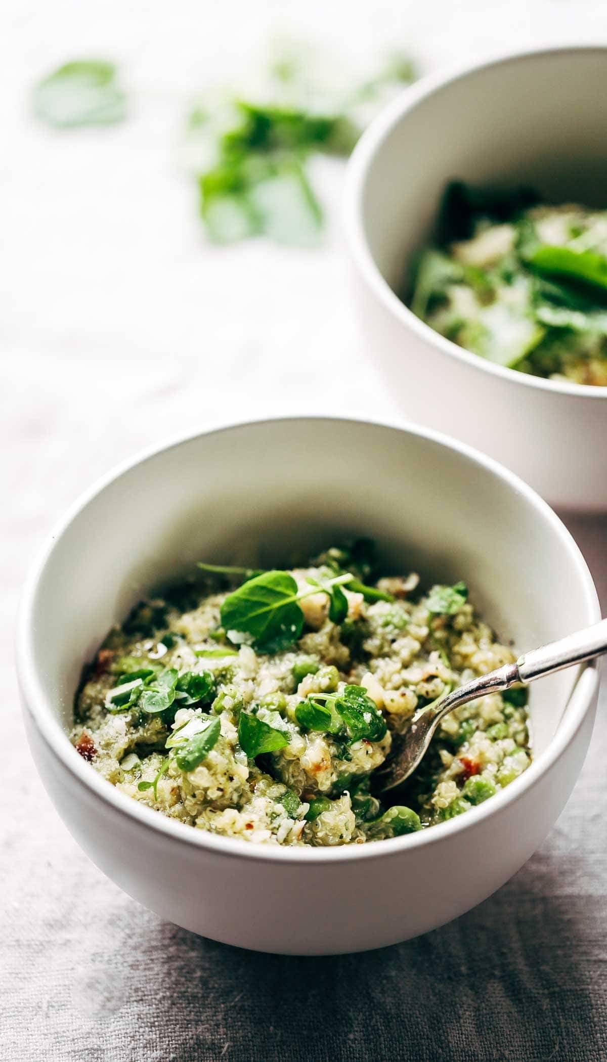 Crockpot Quinoa Chicken Primavera in a white bowl with a fork.