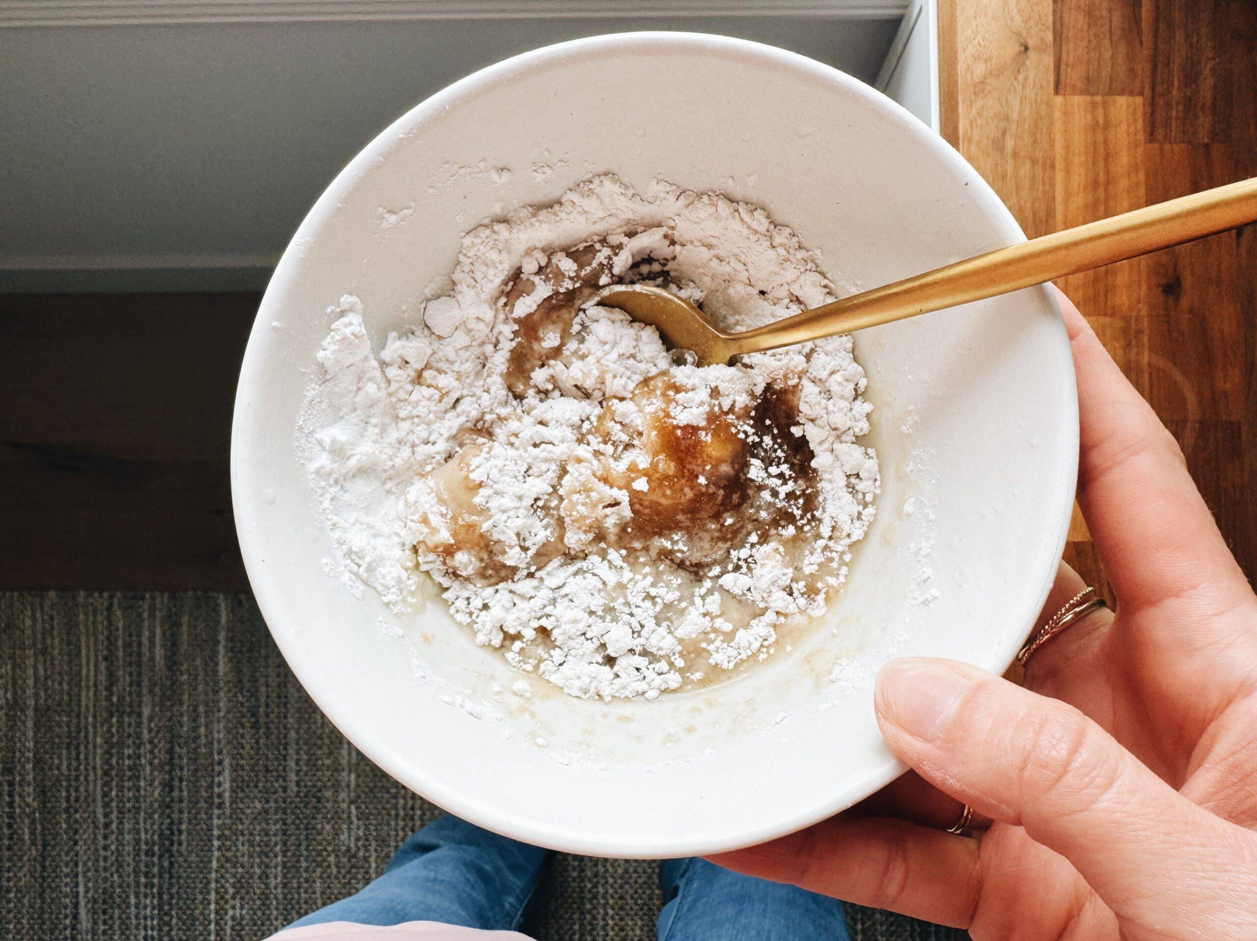 Adding flour to cookie dough.