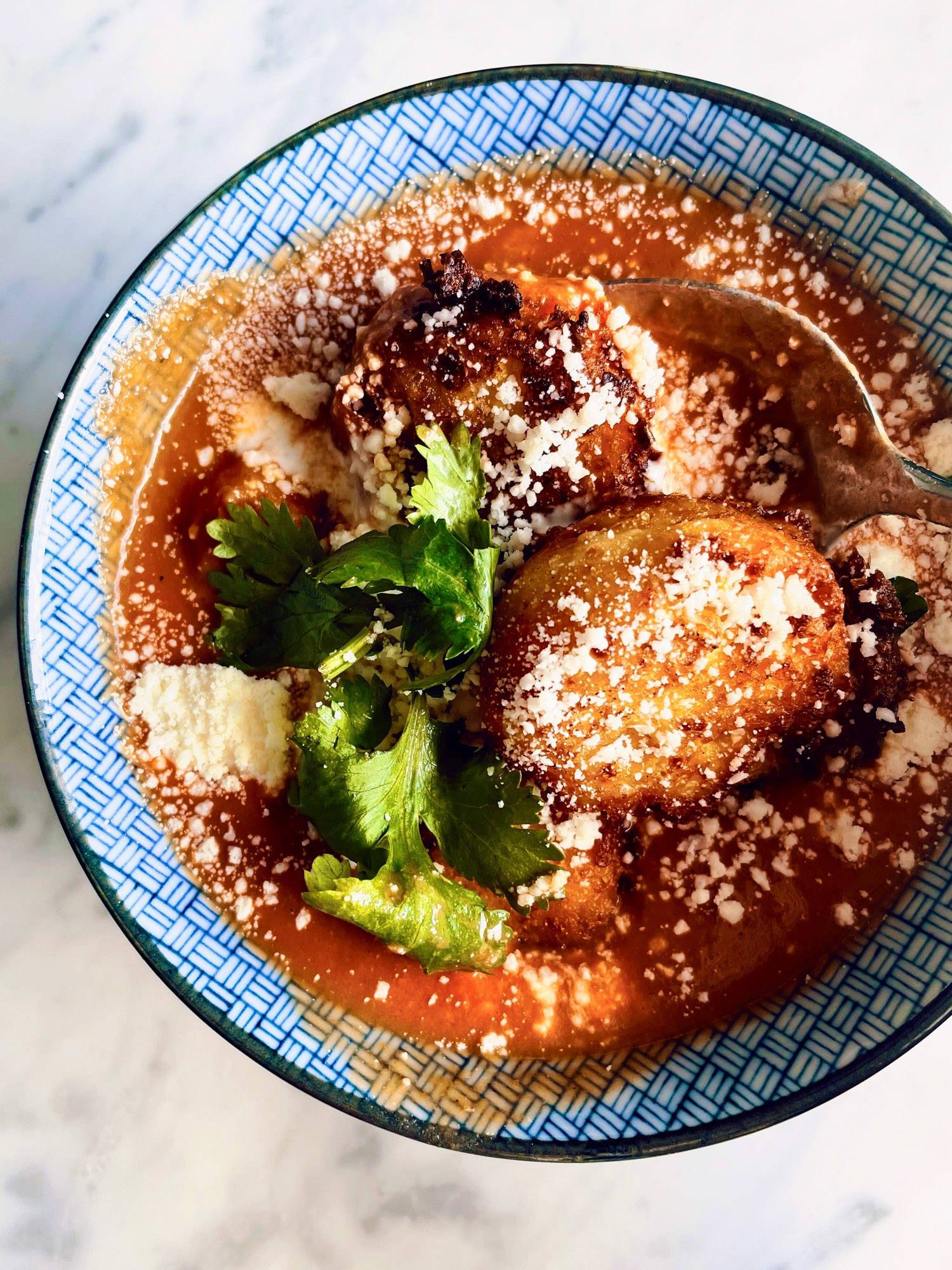 Sopa tarasca in a bowl with cilantro and cheese.