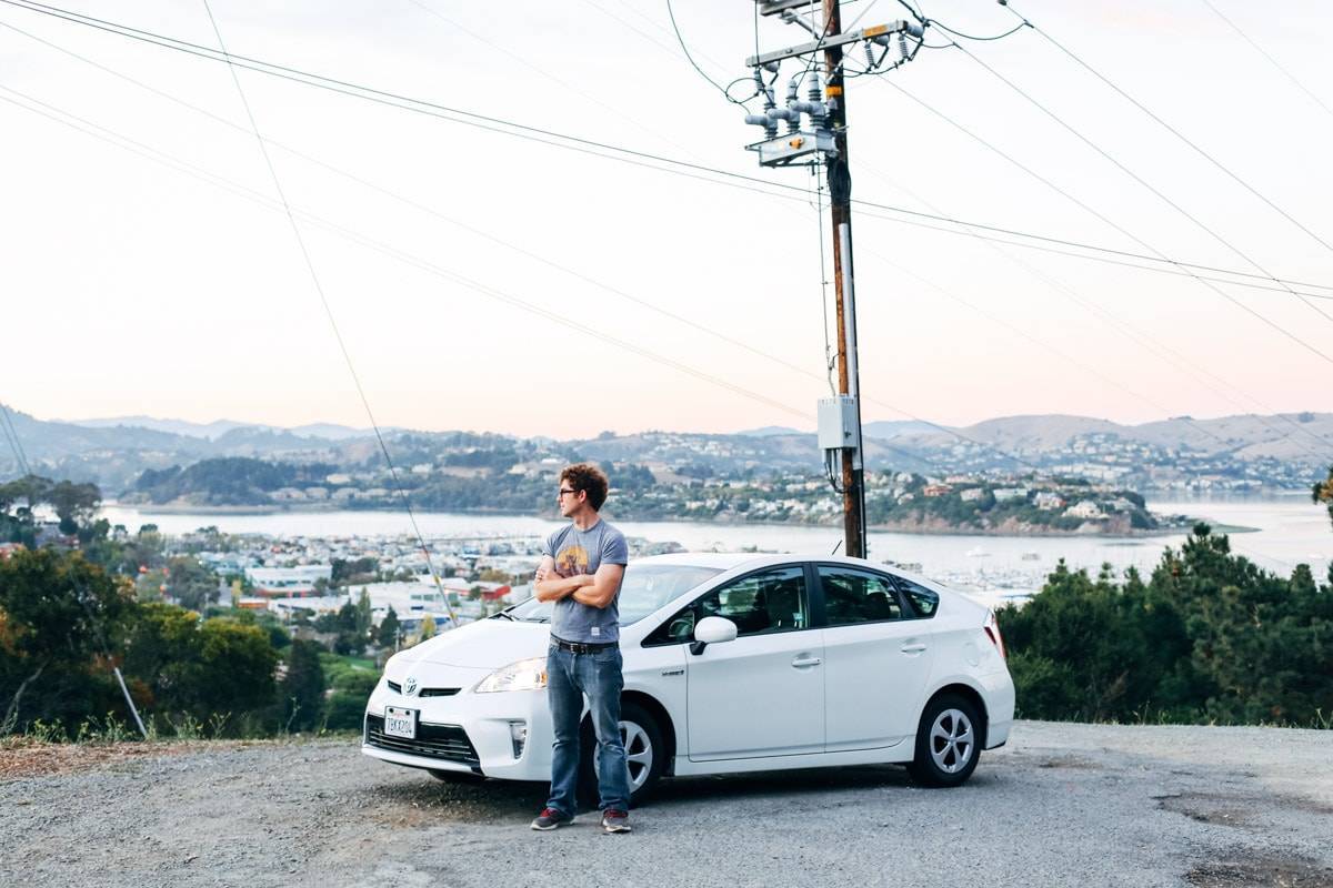 Man standing next to a car.