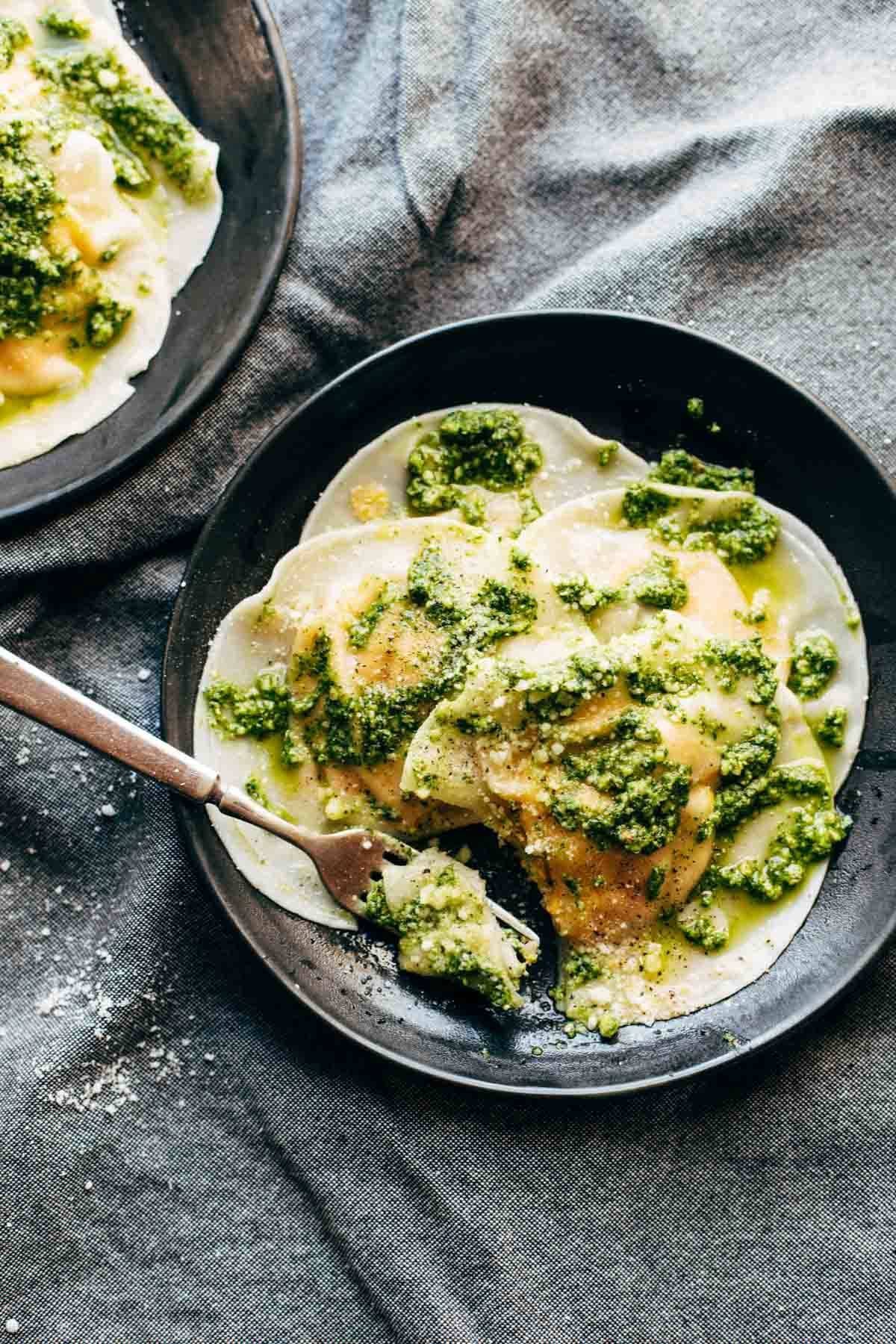 Butternut Squash Ravioli on a plate with a fork.